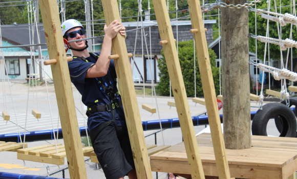 Man climbing at Aerial Ascent Park in Sauble Beach