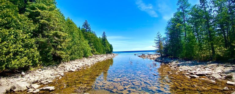Landscape shot of Fathom Five, Canada's first national marine park. Looking down a shallow river flanked by trees on either side