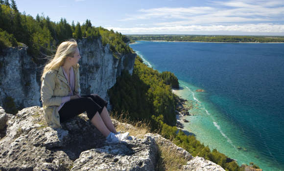 Woman looking out at beautiful landscape of Lion's Head Lookout
