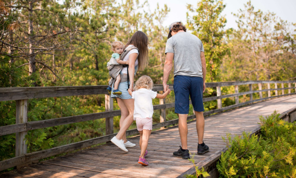 Family going on a walk on a bridge trail 