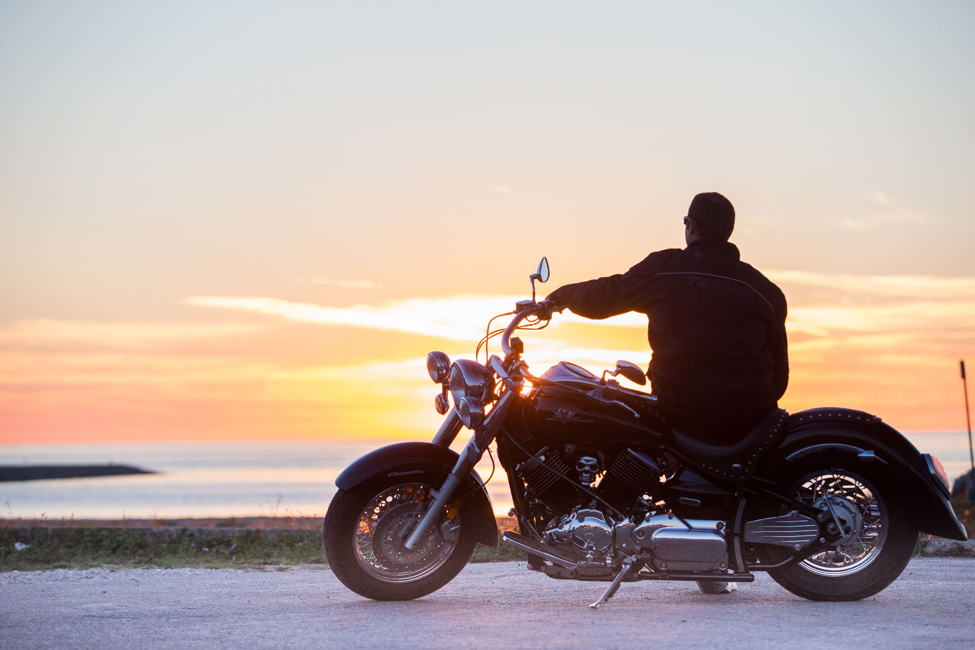 silhouette of a man on a motorbike during golden hour