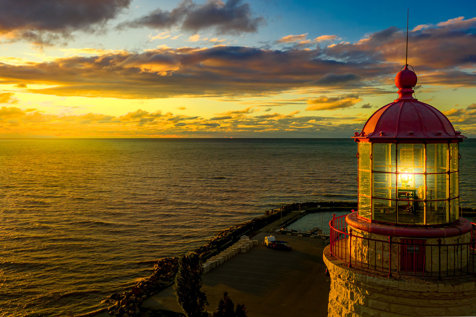 colourful golden sunset with the top of Point Clark lighthouse