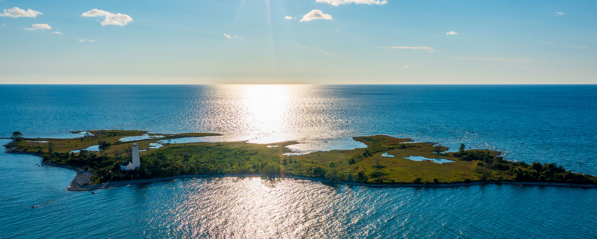 Drone view of Chantry Island with the sun reflected in the water