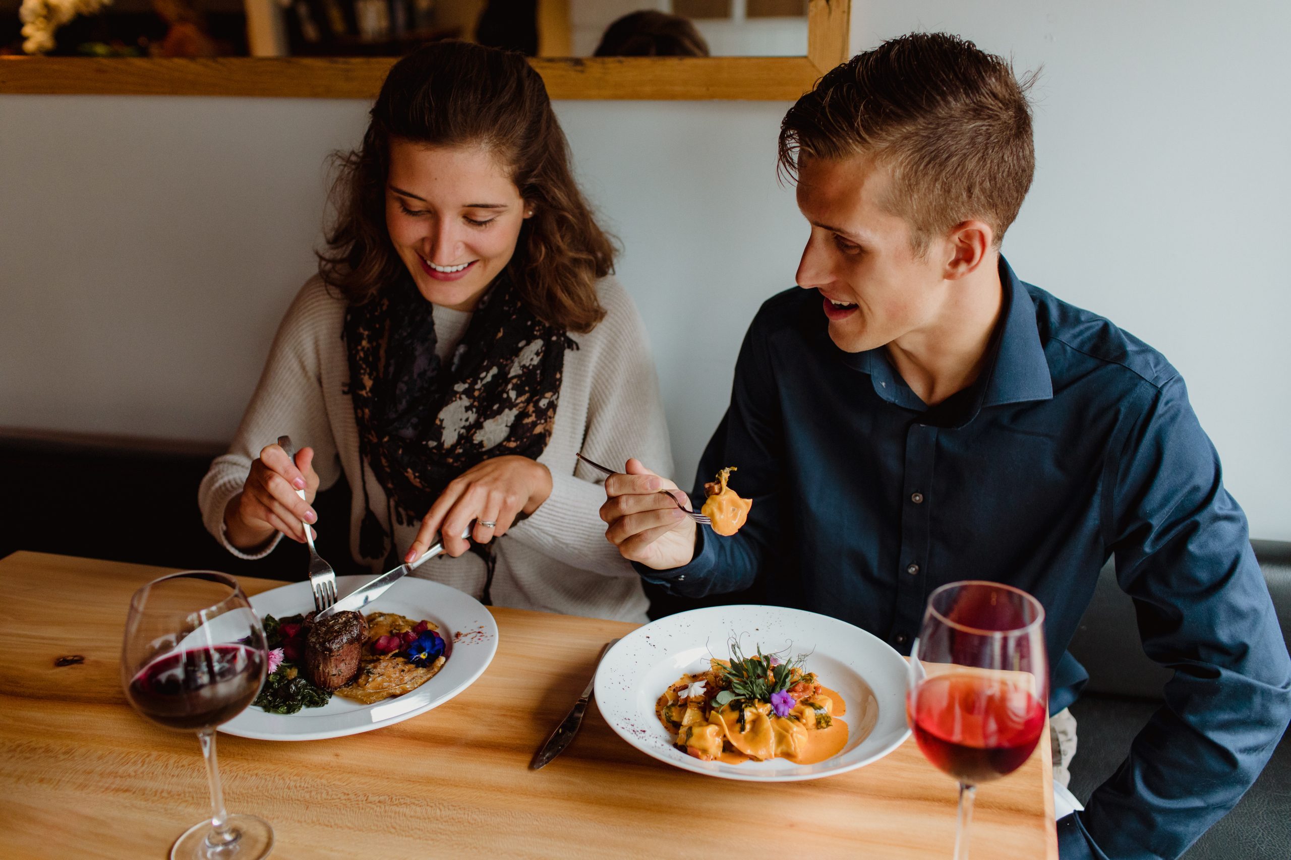 A woman and a man dining out at a fancy restaurant.