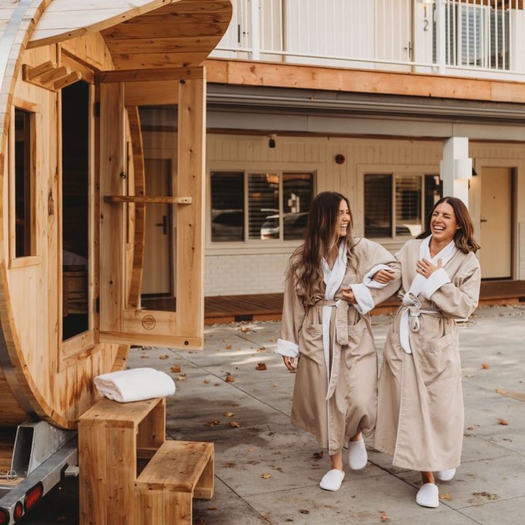 Women at Beach Motel in robes entering sauna