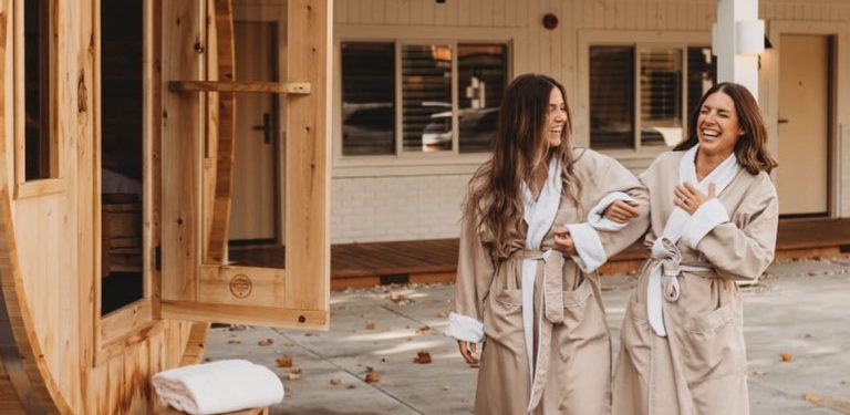 Women at Beach Motel in robes entering sauna