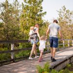 Family walking on boardwalk at MacGregor Point Provincial Park