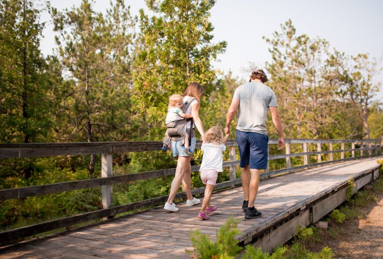 Family walking on boardwalk at MacGregor Point Provincial Park