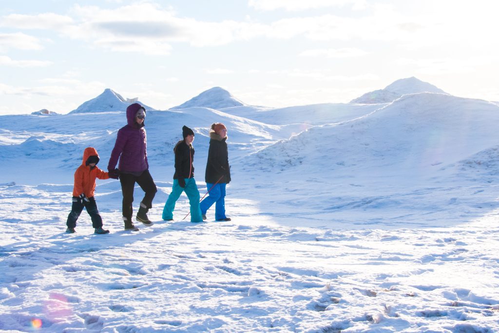 Family walking along the beach in winter