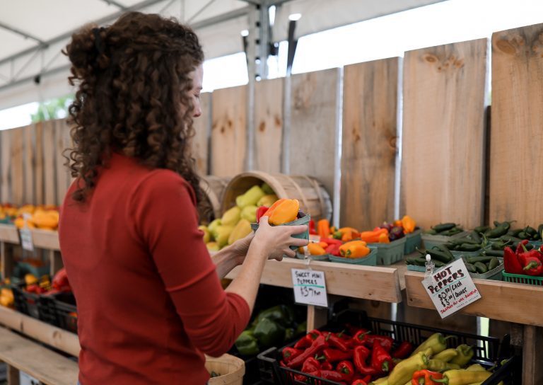 Picking produce at a farmer's market.