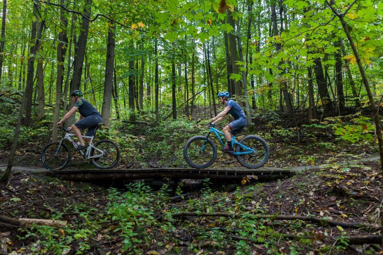 Two bikers on a trail.