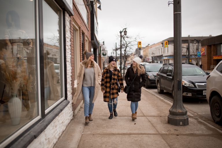 Three women walking in a downtown.